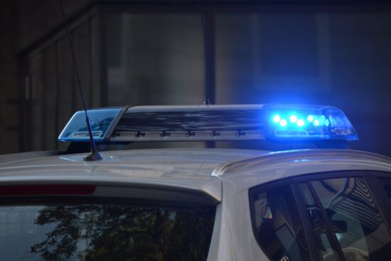 Police car with blue lights flashing.