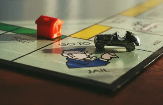 Monopoly board showing "Go to Jail" with car piece
