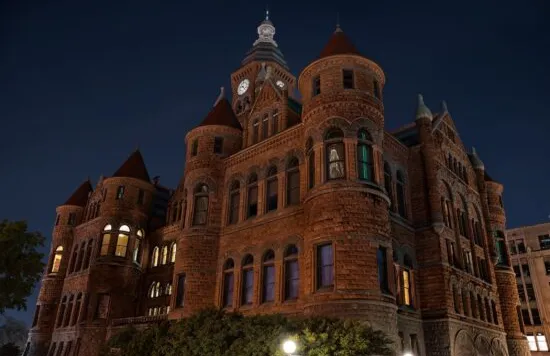 Historic courthouse building illuminated at night.