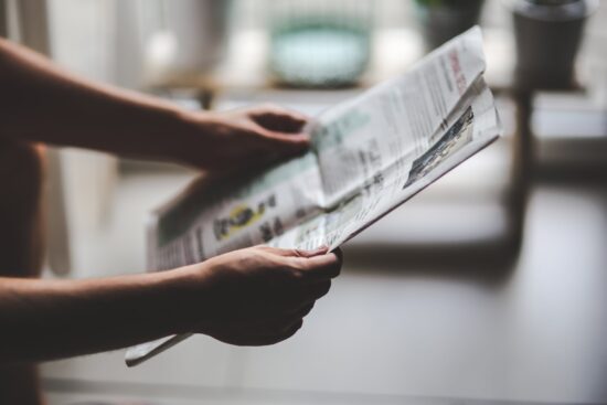 Hands holding Newspaper