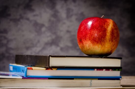 Apple on book stack