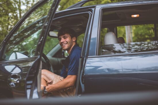smiling man sitting in driver's seat