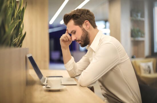 Frustrated man with laptop