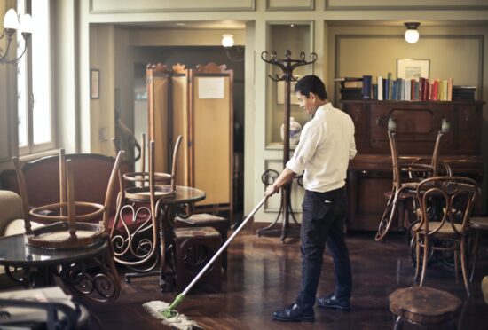 Janitor mopping restaurant