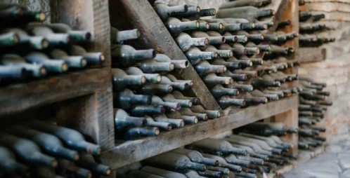An old wine cellar with dusty wine bottles